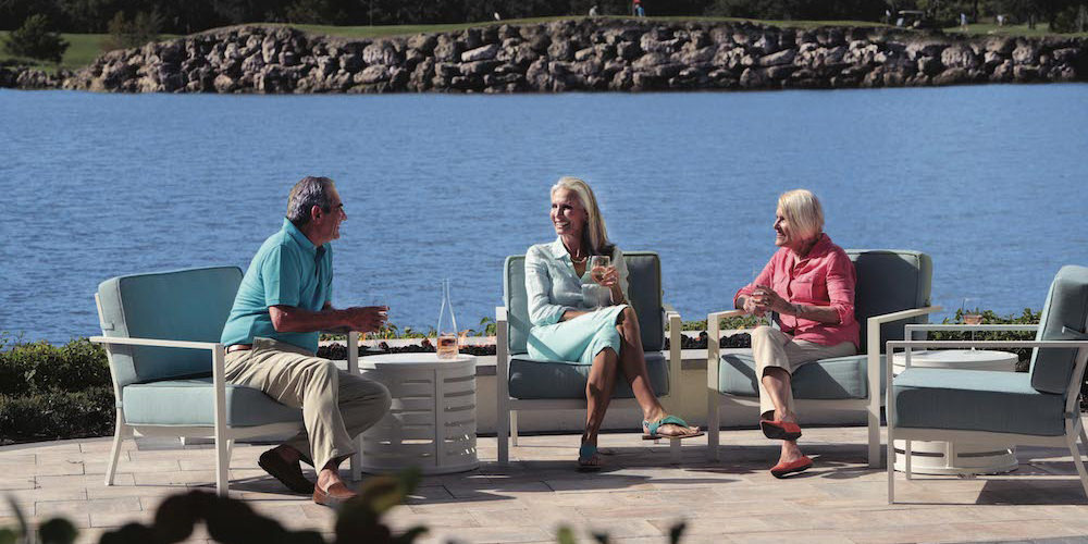 residents enjoying waterfront cocktails at Moorings Park in Naples, Florida