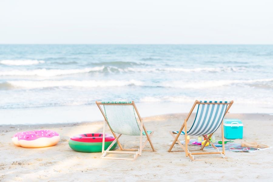 beach chairs on white beach by the ocean