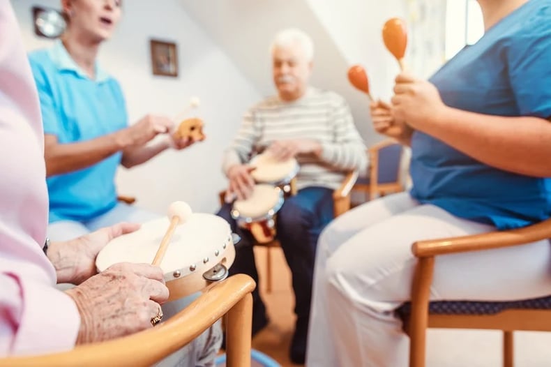 bigstock-Seniors-in-nursing-home-making-323943592