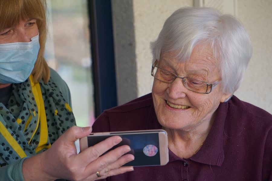 elderly being shown phone